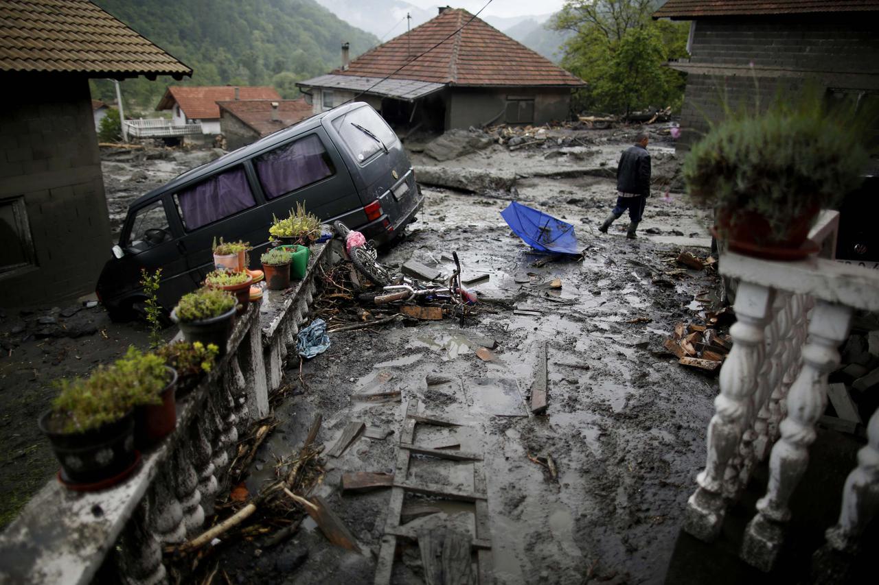 Asim Skopljak walks on a street that was hit by floods in Topcic Polje, near Zepce May 16, 2014. The heaviest rains and floods in 120 years have hit Bosnia and Serbia, killing five people, forcing hundreds out of their homes and cutting off entire towns. 