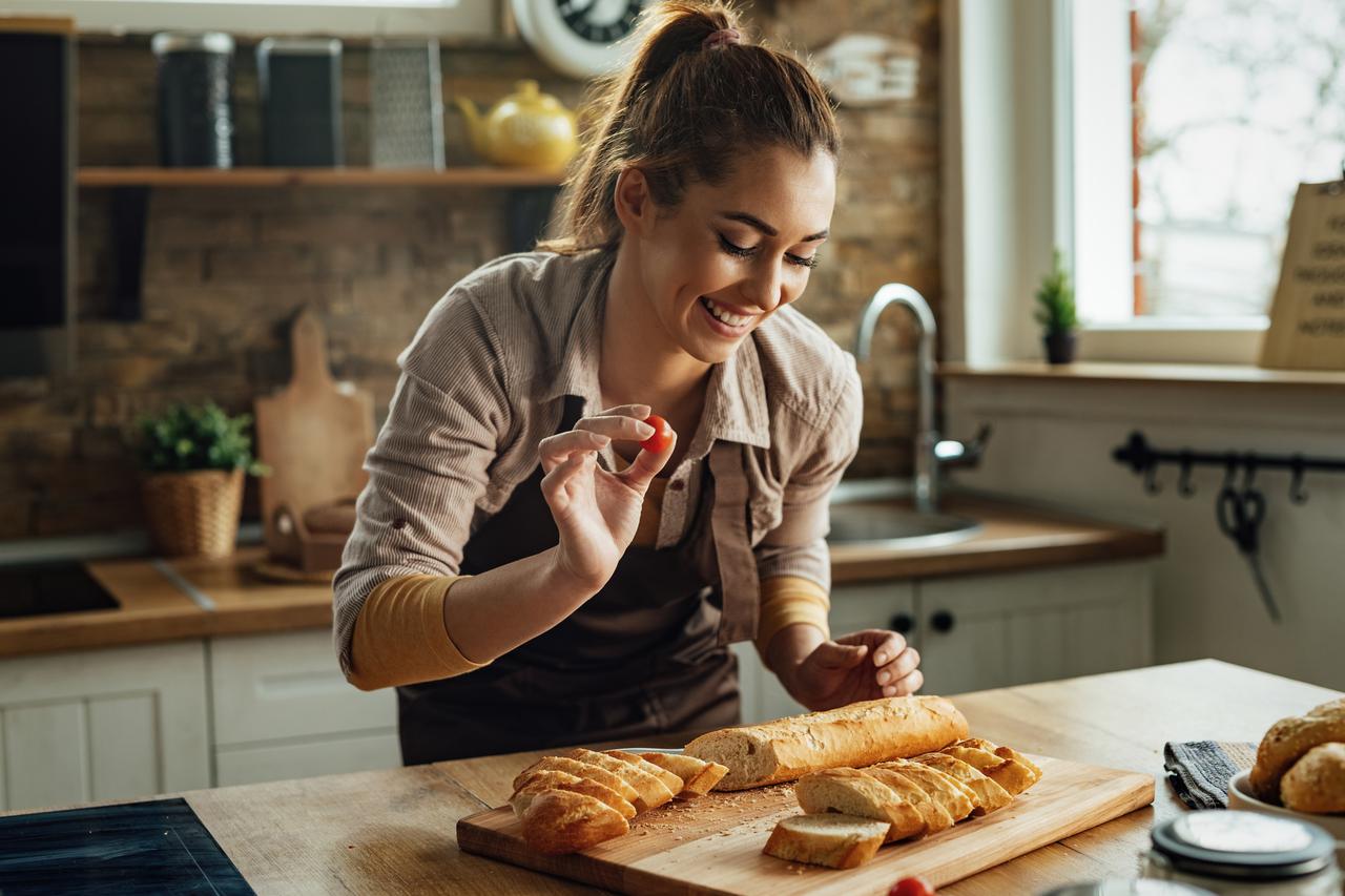 storyeditor/2024-12-16/young-happy-woman-making-bruschetta-while-preparing-food-kitchen.jpg