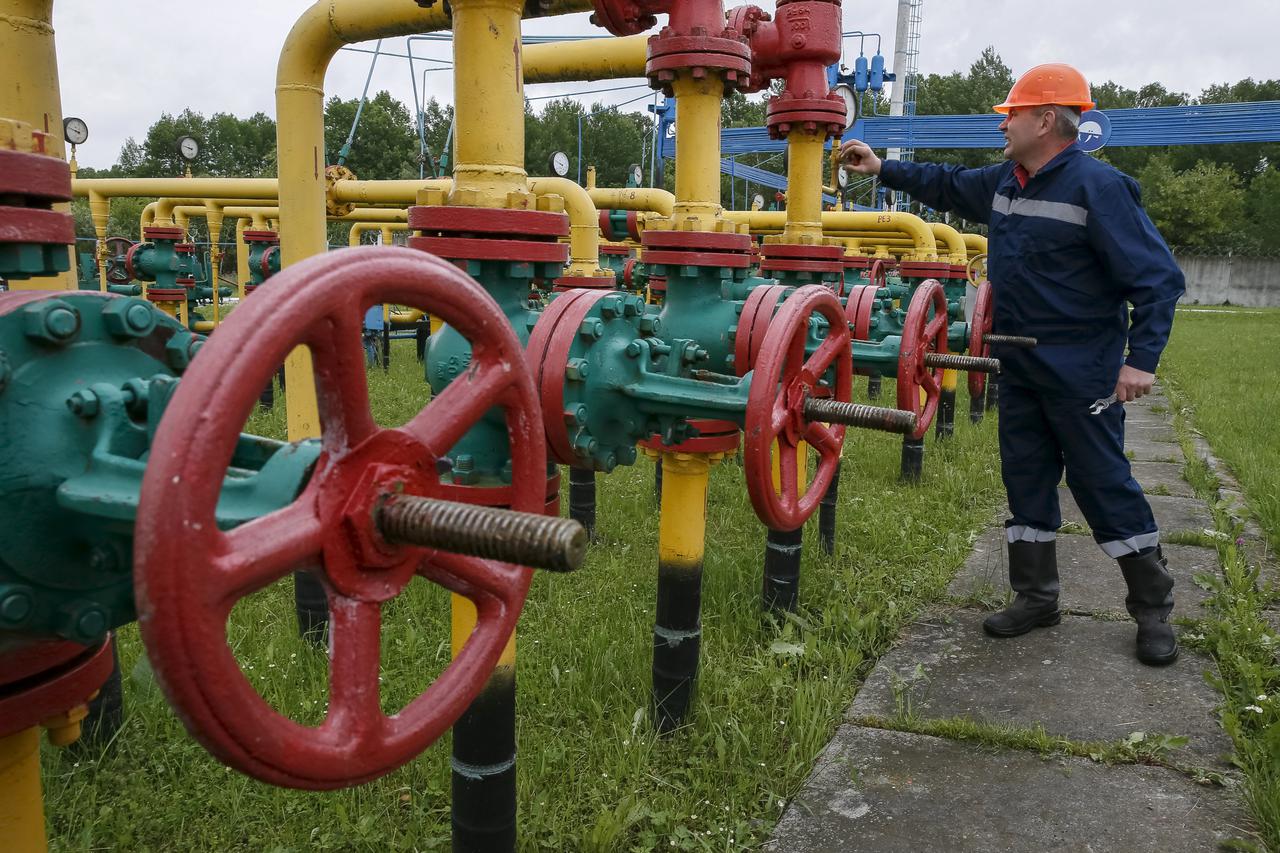 A worker checks equipment at an 